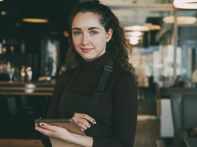 Cafe owner holding a tablet