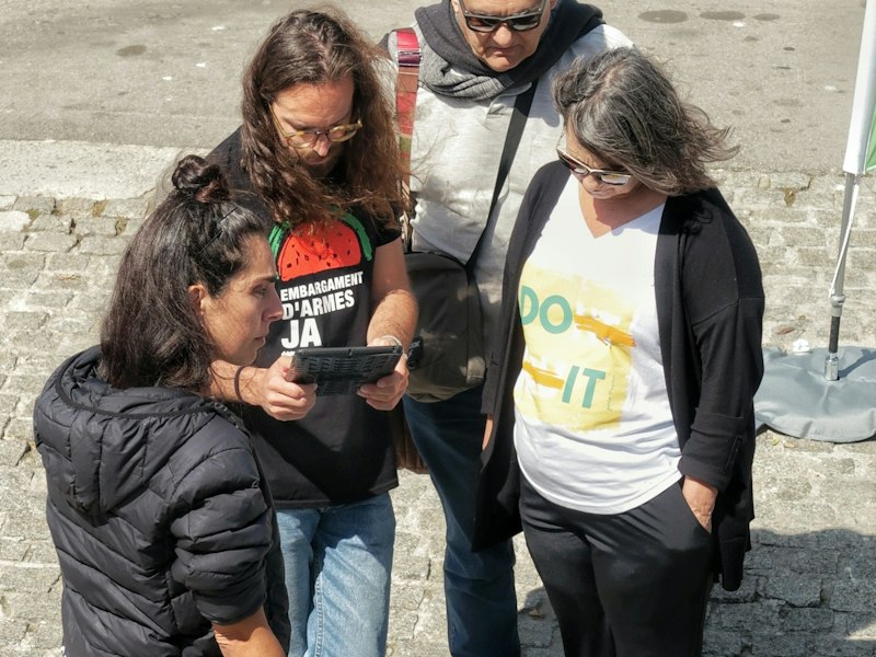 Community volunteers looking at a tablet together