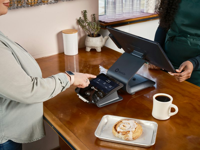 Customer paying at a café counter